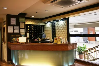 a bar in a restaurant with a wine tasting room at Lourdes Family Suites Makati powered by Cocotel in Manila