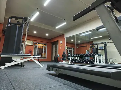 a gym with lots of equipment in a room at Tropicana Suites in Manila