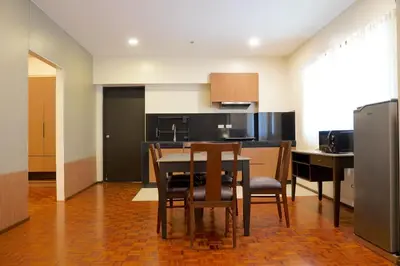 a kitchen and dining room with a table and chairs at Tropicana Suites in Manila