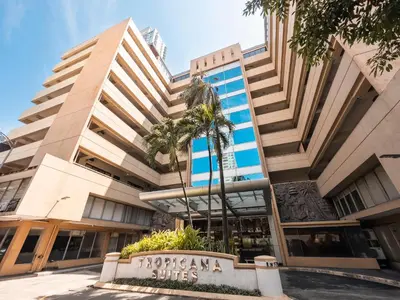 a building with a sign in front of it at Tropicana Suites in Manila