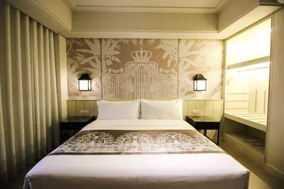 a bedroom with a bed and a wall at Mella Hotel Manila near NAIA Airport in Manila