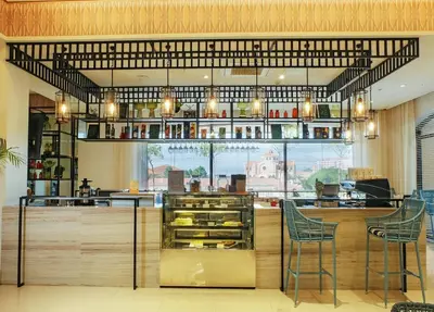 a restaurant with two chairs and a counter with food at Mella Hotel Manila near NAIA Airport in Manila