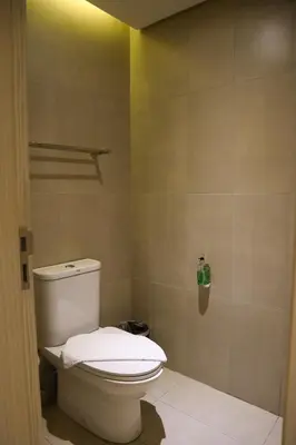 a bathroom with a white toilet in a room at Mella Hotel Manila near NAIA Airport in Manila