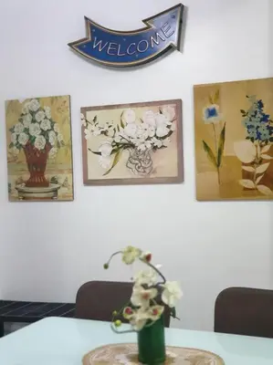 a table with a vase of flowers on a wall at Legarse Staycation at Montecito Residential Resort in Manila