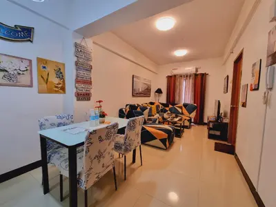 a living room with a table and chairs and a couch at Legarse Staycation at Montecito Residential Resort in Manila