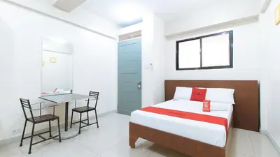 a small bedroom with a bed and a table at RedDoorz near Pasay Taft in Manila