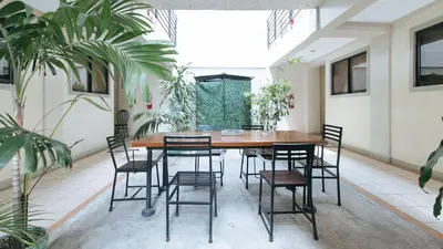 a table and chairs in a room with plants at RedDoorz near Pasay Taft in Manila