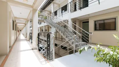 a spiral staircase in a hallway of a building at RedDoorz near Pasay Taft in Manila