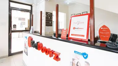 a store checkout counter with red dumbbells on it at RedDoorz near Pasay Taft in Manila
