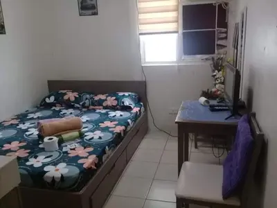 a small bedroom with a bed and a desk and a table at Urban Deca Tower @ Graceysplace Unit 4 Mandaluyong in Manila