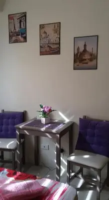 a room with two chairs and a table with flowers on it at Urban Deca Tower Graceysplace Unit unit 3113 Mandaluyong in Manila