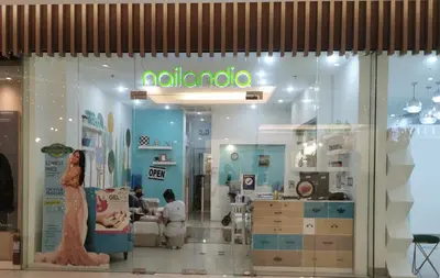 a nelvana store with people sitting in a room at Liam's Pad at grace residences in Manila