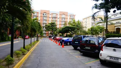 a row of cars parked on the side of a street at 1BR with Balcony Overlooking Pool Chateau Elysee Near NAIA in Manila