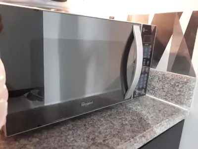 a microwave oven sitting on top of a counter at 1BR with Balcony Overlooking Pool Chateau Elysee Near NAIA in Manila