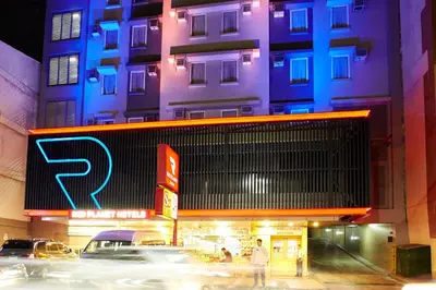 a building with a parking sign in front of it at Red Planet Manila Malate Mabini in Manila