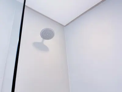 a shower in a white room with a ceiling at Red Planet Manila Malate Mabini in Manila