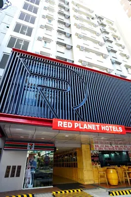 a building with a red planet hotel sign on it at Red Planet Manila Malate Mabini in Manila