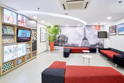 a waiting room with a couch and a tv at Red Planet Manila Malate Mabini in Manila