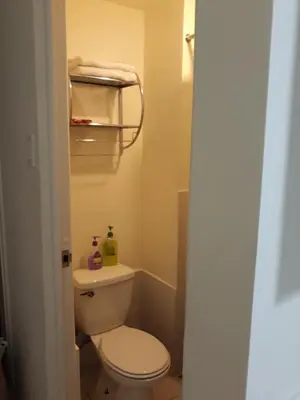 a bathroom with a white toilet in a room at Mandaluyong Stays Inn in Manila