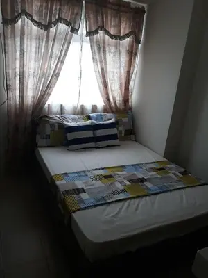 a bed in a room with a window at Mandaluyong Stays Inn in Manila