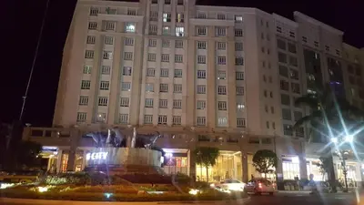 a large building with a fountain in front of it at 101 Newport Boulevard C3 in Manila