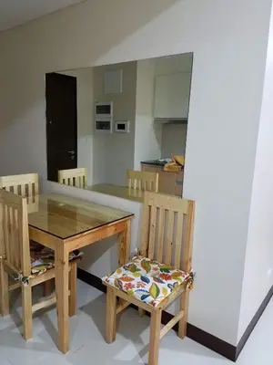 a dining room with a table and two chairs at 101 Newport Boulevard C3 in Manila