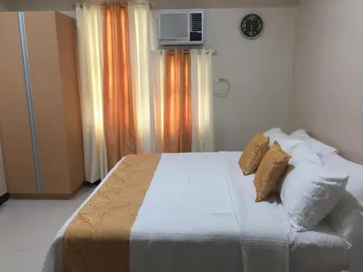 a bedroom with a bed with two pillows on it at 101 Newport Boulevard C3 in Manila