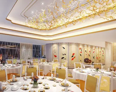 a restaurant with white tables and chairs and a chandelier at Okada Manila in Manila