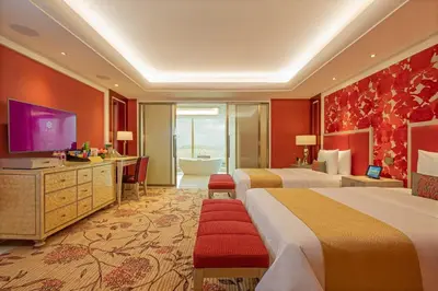 a hotel room with two beds and a television at Okada Manila in Manila
