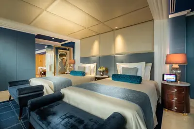 a hotel room with two beds and a couch at Okada Manila in Manila