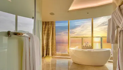 a bathroom with a tub and a large window at Okada Manila in Manila