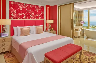 a bedroom with a large bed and a bath tub at Okada Manila in Manila