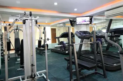 a gym with several tread machines in a room at Prime Avant BGC Location Apartments by PH Staycation in Manila