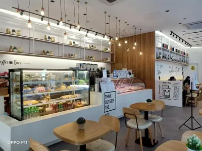 a bakery with two tables and a display case at The Beacon Makati Staycation Suites in Manila