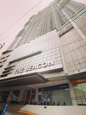 a large building with the beacon sign on it at The Beacon Makati Staycation Suites in Manila