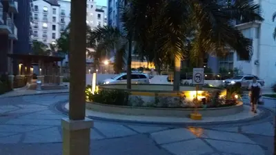 a street with palm trees in a city at night at One Palm Tree Villas close to Manila Airport - Terminal 3 in Manila