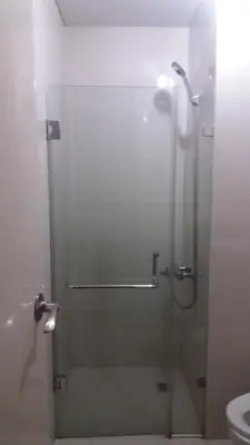 a shower stall with a glass door in a bathroom at One Palm Tree Villas close to Manila Airport - Terminal 3 in Manila