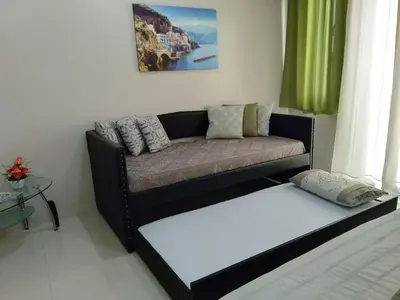 a living room with a couch and a table at One Palm Tree Villas close to Manila Airport - Terminal 3 in Manila
