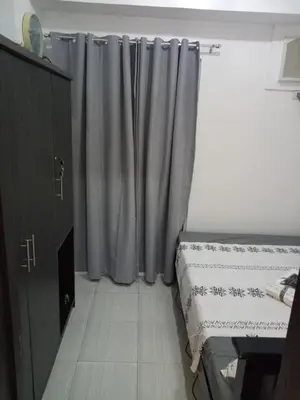 a bedroom with a bed and a window with curtains at Flat NAIA Manila Chateau Elysee pool view in Manila