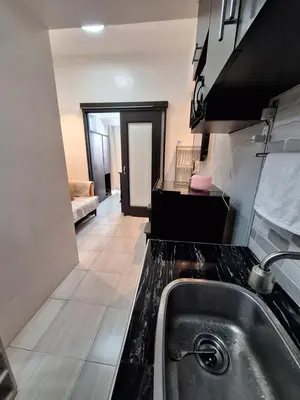 a kitchen with a sink and a counter top at Flat NAIA Manila Chateau Elysee pool view in Manila