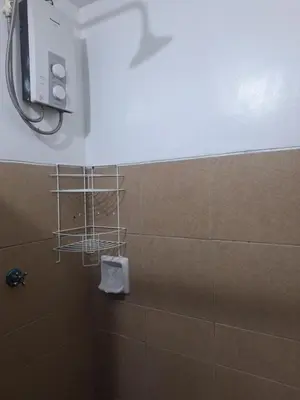 a bathroom with a shower with a towel at Flat NAIA Manila Chateau Elysee pool view in Manila