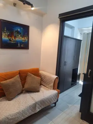 a living room with a couch and a sliding glass door at Flat NAIA Manila Chateau Elysee pool view in Manila