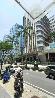 a person on a motorcycle parked on the side of a street at Condotel Walking distance to Airport ( Terminal 3) in Manila
