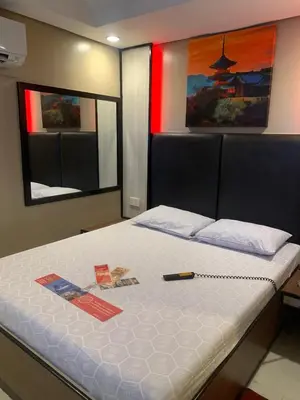 a bedroom with a large bed with a white mattress at Hotel Sogo Malate in Manila