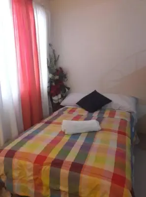 a colorful bed with two towels on top of it at Kassel Dorz Hostel in Manila