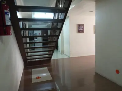 a hallway with a spiral staircase in a building at Kassel Dorz Hostel in Manila