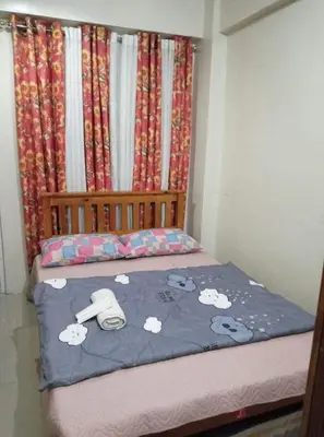 a small bedroom with a bed with hello kitty sheets at Kassel Dorz Hostel in Manila