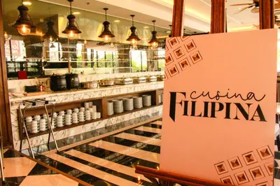 a sign in the window of a food store at 1898 Hotel Colonia En Las Filipinas in Manila