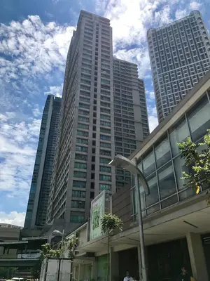 a tall building with a bird statue in front of it at GREENFIELD studio w/ 2 queen across Shangrila in Manila