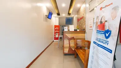 a restaurant with a counter and a table and chairs at RedDoorz near Bambang Station in Manila